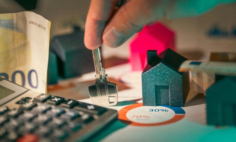 A person putting money into a calculator