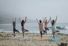 five woman standing on seashore