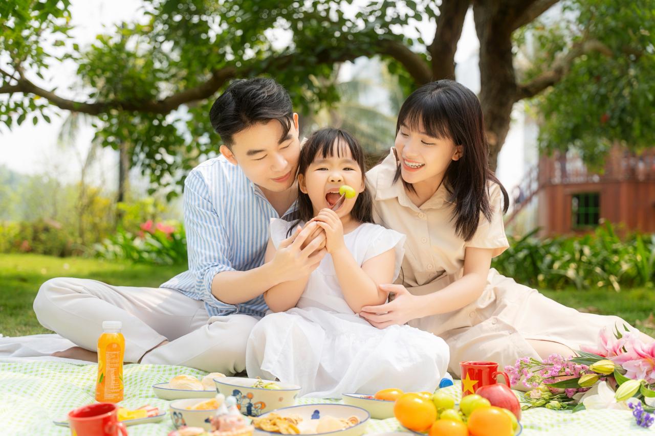 A happy family enjoying a picnic in a park.
